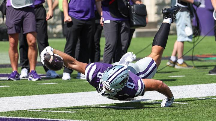 Sep 19, 2026; Manhattan, Kansas, USA; Kansas State Wildcats tight end Linkon Cure (0) reaches for the goal line during the third quarter against the Tulane Green Wave at Bill Snyder Family Football Stadium. Cure was short o the touchdown on the play. Mandatory Credit: Scott Sewell-Imagn Images Sep 19, 2026; Manhattan, Kansas, USA; Kansas State Wildcats tight end Linkon Cure (0) reaches for the goal line during the third quarter against the Tulane Green Wave at Bill Snyder Family Football Stadium. Cure was short o the touchdown on the play. Mandatory Credit: Scott Sewell-Imagn Images