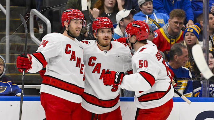Oct 19, 2024; St. Louis, Missouri, USA; Carolina Hurricanes center Jack Roslovic (96) is congratulated by defenseman Jaccob Slavin (74) and left wing Eric Robinson (50) after scoring against the St. Louis Blues during the third period at Enterprise Center. Mandatory Credit: Jeff Curry-Imagn Images Oct 19, 2024; St. Louis, Missouri, USA; Carolina Hurricanes center Jack Roslovic (96) is congratulated by defenseman Jaccob Slavin (74) and left wing Eric Robinson (50) after scoring against the St. Louis Blues during the third period at Enterprise Center. Mandatory Credit: Jeff Curry-Imagn Images