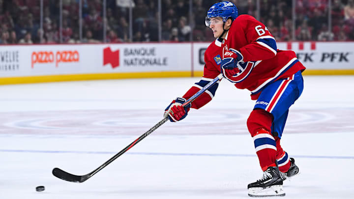 Sep 25, 2025; Montreal, Quebec, CAN; Montreal Canadiens defenseman David Reinbacher (64) shoots the puck Toronto Maple Leafs during the third period at Bell Centre. Mandatory Credit: David Kirouac-Imagn Images