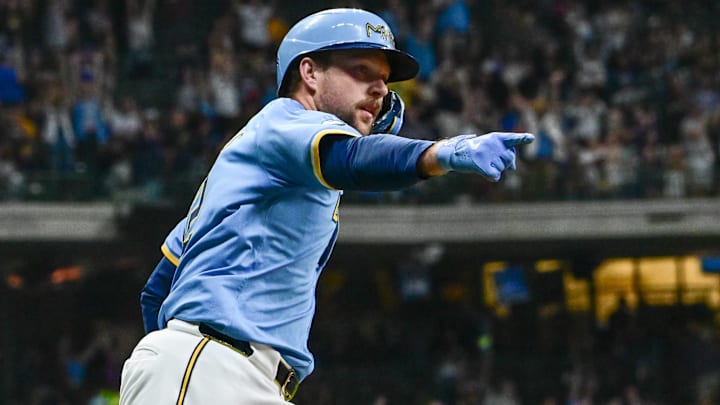 Sep 27, 2024; Milwaukee, Wisconsin, USA;  Milwaukee Brewers first baseman Rhys Hoskins (12) reacts after hitting a grand slam home run against the New York Mets in the first inning at American Family Field. Mandatory Credit: Benny Sieu-Imagn Images