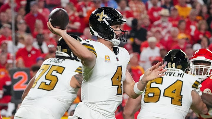 Oct 7, 2024; Kansas City, Missouri, USA; New Orleans Saints quarterback Derek Carr (4) throws a pass against the Kansas City Chiefs during the first half at GEHA Field at Arrowhead Stadium. Mandatory Credit: Denny Medley-Imagn Images