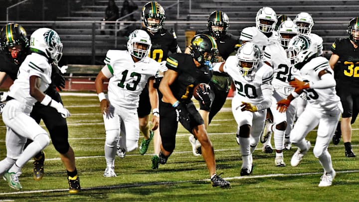 Rock Bridge running back Drevyn Seamon (1) slices through the St. Mary's defense at Rock Bridge High School on Sept. 29, 2023, in Columbia, Mo.