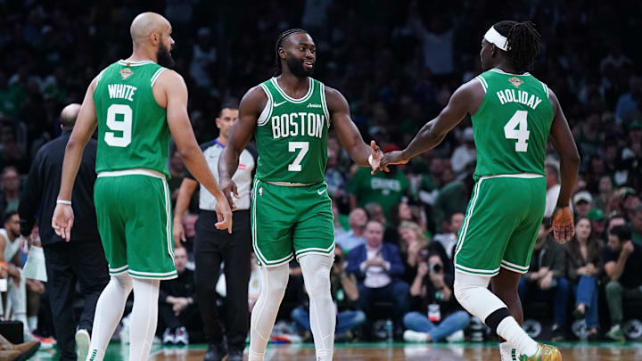 Oct 22, 2024; Boston, Massachusetts, USA; Boston Celtics guard Jaylen Brown (7), guard Jrue Holiday (4) and guard Derrick White (9) react after a play against the New York Knicks in the second half at TD Garden. Mandatory Credit: David Butler II-Imagn Images
