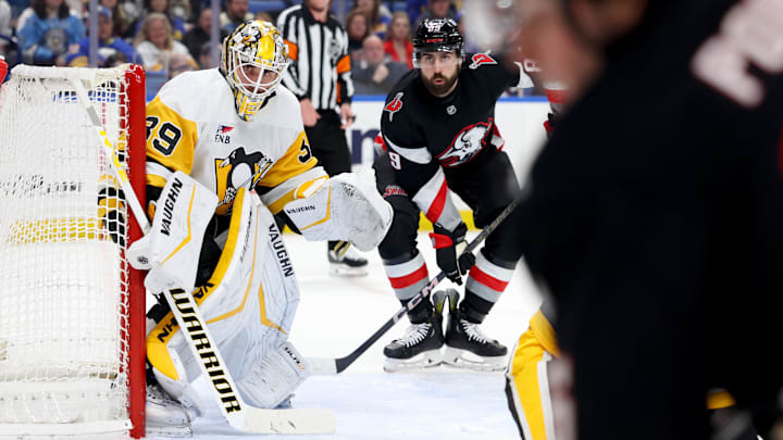 Jan 17, 2025; Buffalo, New York, USA;  Pittsburgh Penguins goaltender Alex Nedeljkovic (39) and Buffalo Sabres right wing Alex Tuch (89) look for the puck during the second period at KeyBank Center. Mandatory Credit: Timothy T. Ludwig-Imagn Images