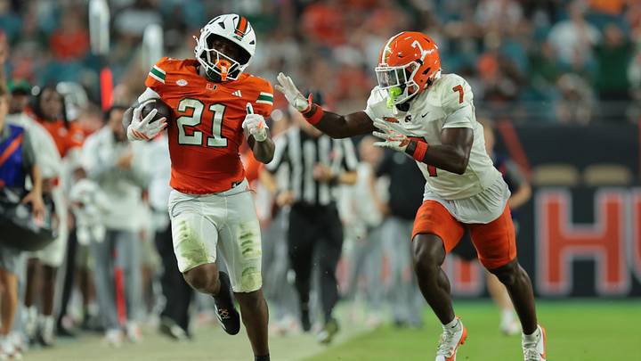 Sep 10, 2026; Miami Gardens, Florida, USA;  Miami Hurricanes running back Javian Mallory (21) carries the ball while defended by Florida A&M Rattlers defensive back Andre Powell Jr. (7) in the third quarter at Hard Rock Stadium.  Mandatory Credit: Sam Navarro-Imagn Images