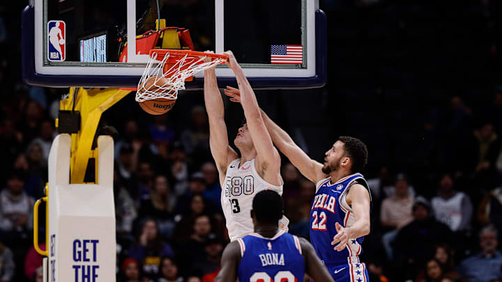 Jan 21, 2025; Denver, Colorado, USA; Denver Nuggets center PJ Hall (13) dunks the ball against Philadelphia 76ers forward Pete Nance (22) as center Adem Bona (30) defends in the fourth quarter at Ball Arena. Mandatory Credit: Isaiah J. Downing-Imagn Images