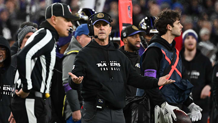 Jan 28, 2024; Baltimore, Maryland, USA; Baltimore Ravens head coach John Harbaugh (center) questions