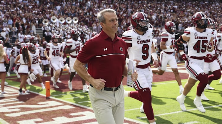 Nov 15, 2025; College Station, Texas, USA; South Carolina Gamecocks head coach Shane Beamer runs onto the field with players before the game against the Texas A&M Aggies at Kyle Field. Mandatory Credit: Troy Taormina-Imagn Images