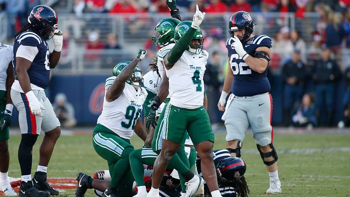 Dec 20, 2025; Oxford, MS, USA; Tulane Green Wave linebacker Chris Rodgers (4) and defensive tackle Eliyt Nairne (90) reacts to a defensive play against the Mississippi Rebels during the first half of a game at Vaught-Hemingway Stadium. Mandatory Credit: Petre Thomas-Imagn Images Dec 20, 2025; Oxford, MS, USA; Tulane Green Wave linebacker Chris Rodgers (4) and defensive tackle Eliyt Nairne (90) reacts to a defensive play against the Mississippi Rebels during the first half of a game at Vaught-Hemingway Stadium. Mandatory Credit: Petre Thomas-Imagn Images