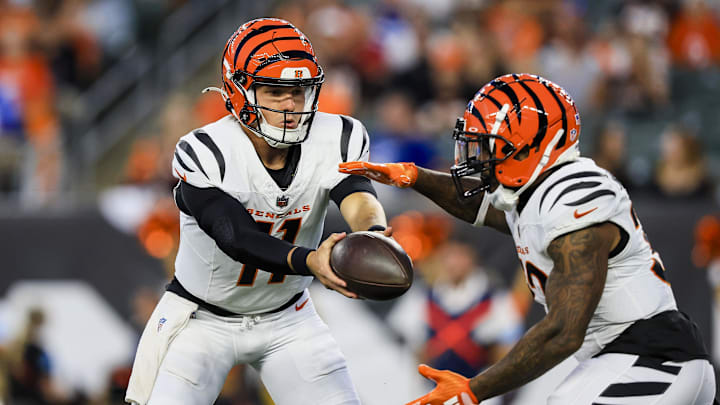 Aug 22, 2024; Cincinnati, Ohio, USA; Cincinnati Bengals quarterback Logan Woodside (11) hands off the ball to running back Trayveon Williams (32) in the first half against the Indianapolis Colts at Paycor Stadium. Mandatory Credit: Katie Stratman-Imagn Images