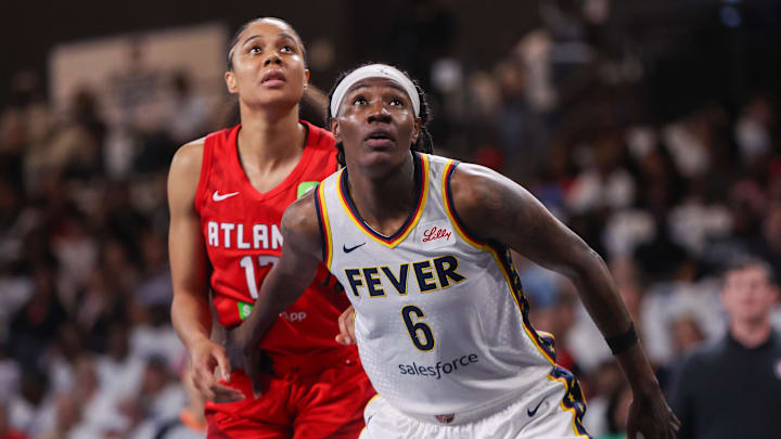 Sep 14, 2025; College Park, Georgia, USA; Indiana Fever forward Natasha Howard (6) boxes out Atlanta Dream forward Nia Coffey (12) in the second quarter during game one of round one for the 2025 WNBA Playoffs at Gateway Center Arena at College Park. Mandatory Credit: Brett Davis-Imagn Images