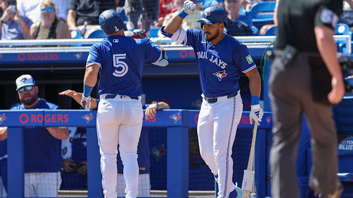 Mar 2, 2025: Toronto Blue Jays outfielder Anthony Santander (25) congratulates outfielder Daulton Varsho (5) after hitting home run against the Philadelphia Phillies in the first inning during spring training at TD Ballpark. 