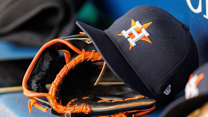 Apr 27, 2025; Kansas City, Missouri, USA; Houston Astros hat and glove in the dugout during the second inning against the Kansas City Royals at Kauffman Stadium. Mandatory Credit: William Purnell-Imagn Images