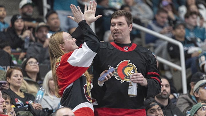 Nov 22, 2025; San Jose, California, USA;  Ottawa Senators fans celebrate after the team scored a goal during the second period against the San Jose Sharks at SAP Center at San Jose. Mandatory Credit: Stan Szeto-Imagn Images