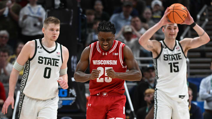 Wisconsin Badgers guard John Blackwell (25) celebrates after a play in front of Michigan State Spartans forward Jaxon Kohler (0) and Michigan State Spartans center Carson Cooper (15) during the second half at Gainbridge Fieldhouse. 