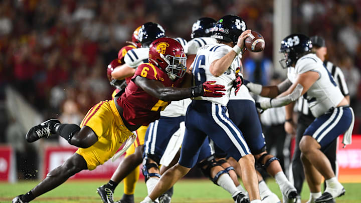 Sep 7, 2024; Los Angeles, California, USA; USC Trojans defensive end Anthony Lucas (6) attempts to sack Utah State Aggies quarterback Bryson Barnes (16) during the second quarter at United Airlines Field at Los Angeles Memorial Coliseum. Mandatory Credit: Jonathan Hui-Imagn Images Sep 7, 2024; Los Angeles, California, USA; USC Trojans defensive end Anthony Lucas (6) attempts to sack Utah State Aggies quarterback Bryson Barnes (16) during the second quarter at United Airlines Field at Los Angeles Memorial Coliseum. Mandatory Credit: Jonathan Hui-Imagn Images