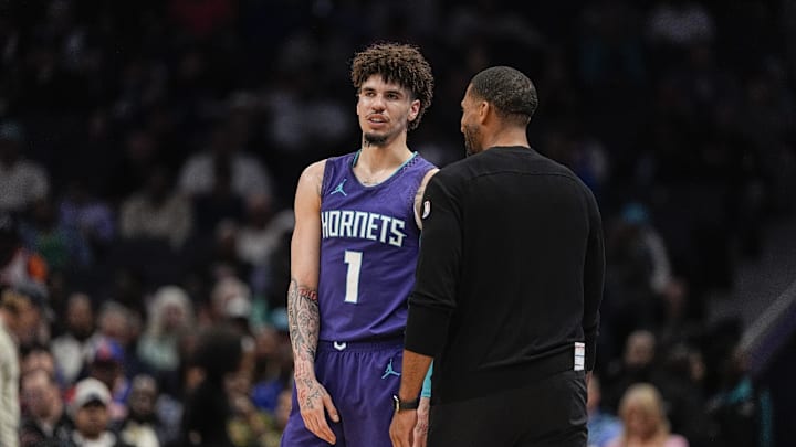 Mar 20, 2025; Charlotte, North Carolina, USA; Charlotte Hornets guard LaMelo Ball (1) talks with head coach Charles Lee  during a  free throw during the second half against the New York Knicks at Spectrum Center. Mandatory Credit: Jim Dedmon-Imagn Images