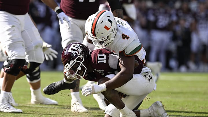 Dec 20, 2025; College Station, TX, USA; Texas A&M Aggies quarterback Marcel Reed (10) is sacked by Miami Hurricanes defensive lineman Rueben Bain Jr. (4) during the second half of the first round game of the CFP National Playoff at Kyle Field. Mandatory Credit: Jerome Miron-Imagn Images