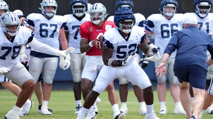 Dallas Cowboys quarterback Dak Prescott prepares to take the snap as guard Tyler Booker reacts. Dallas Cowboys quarterback Dak Prescott prepares to take the snap as guard Tyler Booker reacts.
