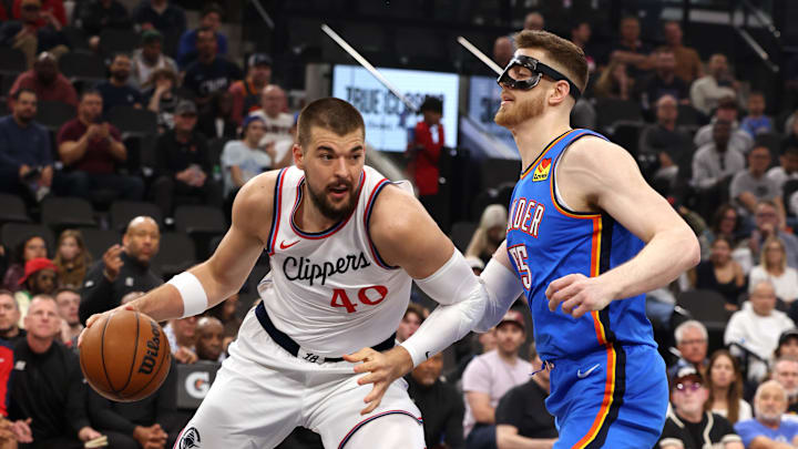 Mar 23, 2025; Inglewood, California, USA; LA Clippers center Ivica Zubac (40) dribbles against Oklahoma City Thunder center Isaiah Hartenstein (55) during the 1st quarter at Intuit Dome. Mandatory Credit: Jason Parkhurst-Imagn Images