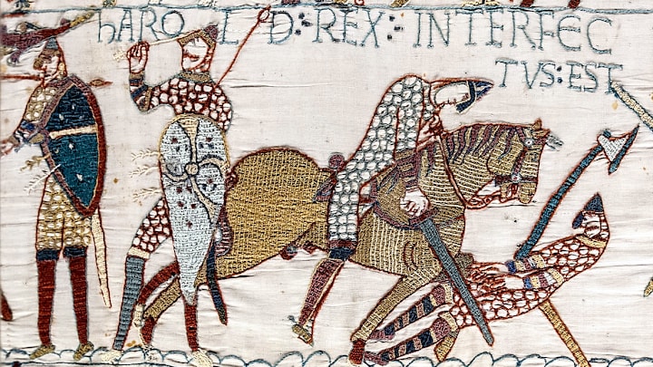 Harold (second from left) grasps the arrow that is apparently in his eye.