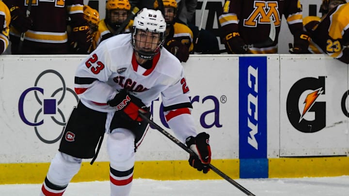 St. Cloud State men's hockey freshman Austin Burnevik reaches for the puck during an exhibition game Oct. 5 at home against Minnesota. The Huskies lost 5-1.