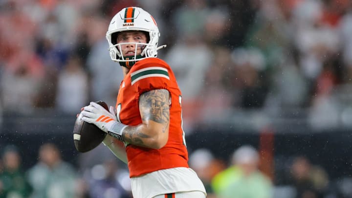 Sep 20, 2025; Miami Gardens, Florida, USA; Miami Hurricanes quarterback Carson Beck (11) looks for passing option against the Florida Gators during the first quarter at Hard Rock Stadium. Mandatory Credit: Sam Navarro-Imagn Images Sep 20, 2025; Miami Gardens, Florida, USA; Miami Hurricanes quarterback Carson Beck (11) looks for passing option against the Florida Gators during the first quarter at Hard Rock Stadium. Mandatory Credit: Sam Navarro-Imagn Images