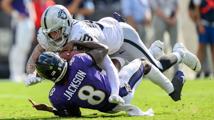 Sep 15, 2024; Baltimore, Maryland, USA; Las Vegas Raiders defensive end Maxx Crosby (98) sacks Baltimore Ravens quarterback Lamar Jackson (8) during the second half at M&T Bank Stadium. Mandatory Credit: Reggie Hildred-Imagn Images