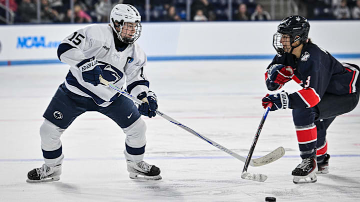 Penn State hockey player Tessa Janecke goes for the puck during a Nittany Lions hockey game.
