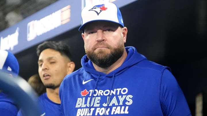 Oct 12, 2025; Toronto, Ontario, CAN; Toronto Blue Jays manager John Schneider (14) looks on before game one against the Seattle Mariners in the ALCS round for the 2025 MLB playoffs at Rogers Centre. Oct 12, 2025; Toronto, Ontario, CAN; Toronto Blue Jays manager John Schneider (14) looks on before game one against the Seattle Mariners in the ALCS round for the 2025 MLB playoffs at Rogers Centre.
