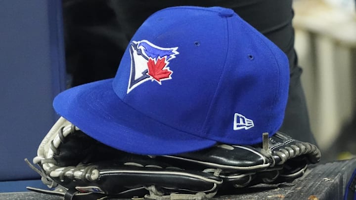 Apr 27, 2024; Toronto, Ontario, CAN; A Toronto Blue Jays hat and glove in the dugout during the third inning against the Los Angeles Dodgers at Rogers Centre. 