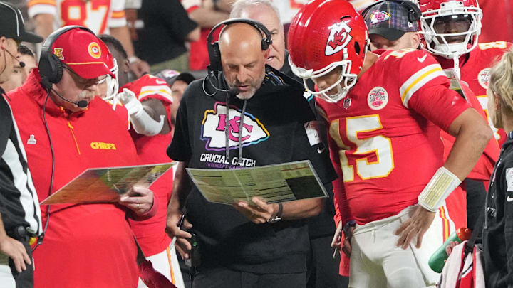 Oct 7, 2024; Kansas City, Missouri, USA; Kansas City Chiefs quarterback Patrick Mahomes (15) looks at plays with offensive coordinator Matt Nagy, center, and head coach Andy Reid against the New Orleans Saints during the first half at GEHA Field at Arrowhead Stadium. Mandatory Credit: Denny Medley-Imagn Images