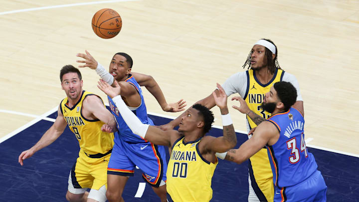 Jun 19, 2025; Indianapolis, Indiana, USA; Oklahoma City Thunder guard Aaron Wiggins (21) goes after a loose ball against Indiana Pacers guard T.J. McConnell (9) and guard Bennedict Mathurin (00) in the fourth quarter during game six of the 2025 NBA Finals at Gainbridge Fieldhouse. Mandatory Credit: Trevor Ruszkowski-Imagn Images