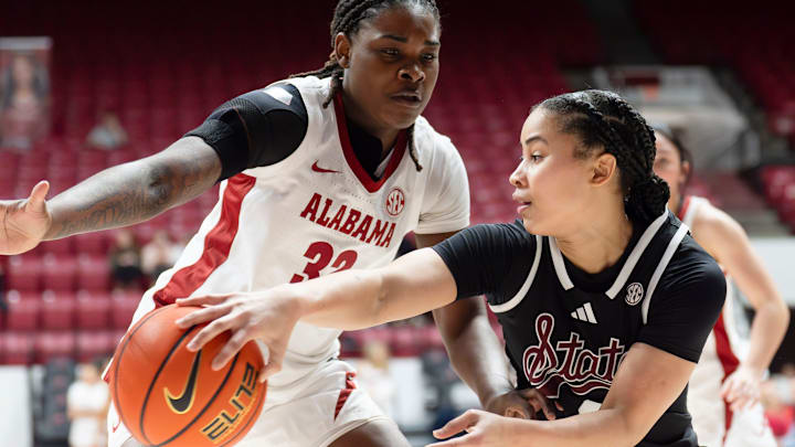 Mississippi State guard Saniyah King (1) slips a pass around Alabama forward Alancia Ramsey (32) at Coleman Coliseum in Tuscaloosa, Ala.