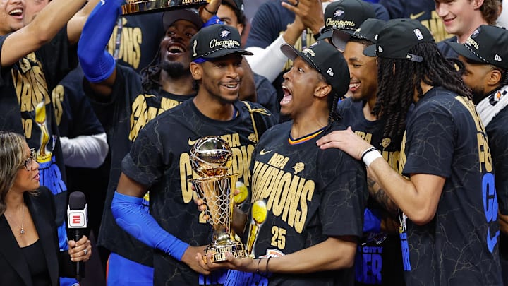 Jun 22, 2025; Oklahoma City, Oklahoma, USA; Oklahoma City Thunder forward Jalen Williams (8) holds up the Bill Russell NBA Finals MVP trophy after winner Oklahoma City Thunder guard Shai Gilgeous-Alexander hands it to him at the end of game seven of the 2025 NBA Finals against the Indiana Pacers at Paycom Center. Mandatory Credit: Alonzo Adams-Imagn Images