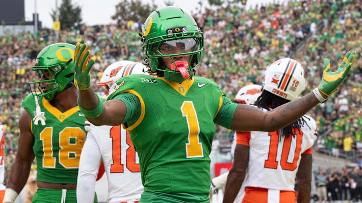Oregon’s Dakorien Moore celebrates with Duck fans during the game against Oklahoma State.