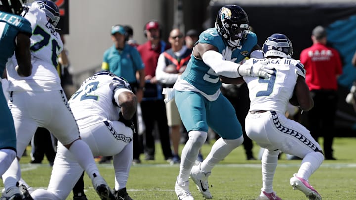 Oct 12, 2025; Jacksonville, Florida, USA; Jacksonville Jaguars defensive end Emmanuel Ogbah (90) tackles Seattle Seahawks running back Kenneth Walker III (9) during the first half at EverBank Stadium. Mandatory Credit: Travis Register-Imagn Images Oct 12, 2025; Jacksonville, Florida, USA; Jacksonville Jaguars defensive end Emmanuel Ogbah (90) tackles Seattle Seahawks running back Kenneth Walker III (9) during the first half at EverBank Stadium. Mandatory Credit: Travis Register-Imagn Images