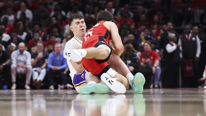 Apr 26, 2026; Houston, Texas, USA; Houston Rockets guard Reed Sheppard (15) attempts to get control of the ball away from Los Angeles Lakers forward Jake LaRavia (12) during the third quarter during game four of the first round of the 2026 NBA Playoffs at Toyota Center. Mandatory Credit: Troy Taormina-Imagn Images