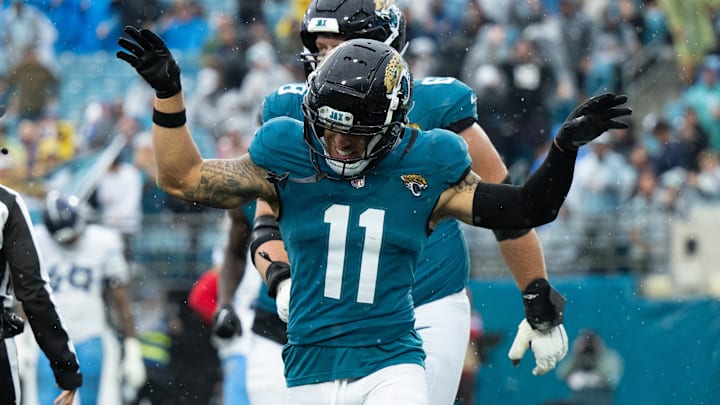 Dec 29, 2024; Jacksonville, Florida, USA;  Jacksonville Jaguars wide receiver Parker Washington (11) celebrates his touchdown against the Tennessee Titans in the second quarter at EverBank Stadium. Mandatory Credit: Jeremy Reper-Imagn Images