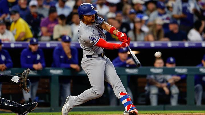 Apr 20, 2026; Denver, Colorado, USA; Los Angeles Dodgers second baseman Santiago Espinal (21) hits a single in the fourth inning against the Colorado Rockies at Coors Field. Mandatory Credit: Isaiah J. Downing-Imagn Images