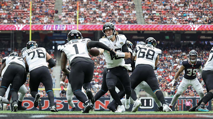 Sep 29, 2024; Houston, Texas, USA; Jacksonville Jaguars quarterback Trevor Lawrence (16) hands off to running back Travis Etienne Jr. (1) during the fourth quarter against the Houston Texans at NRG Stadium. Mandatory Credit: Troy Taormina-Imagn Images