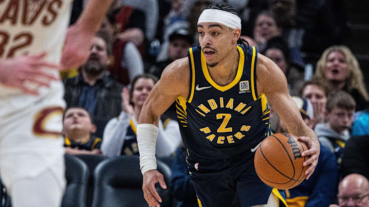 Jan 14, 2025; Indianapolis, Indiana, USA;  Indiana Pacers guard Andrew Nembhard (2) dribbles the ball in the second half against the Cleveland Cavaliers at Gainbridge Fieldhouse. Mandatory Credit: Trevor Ruszkowski-Imagn Images