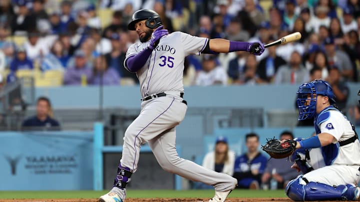 Jun 1, 2024; Los Angeles, California, USA;  Colorado Rockies catcher Elias Diaz (35) hits a single during the third inning against the Los Angeles Dodgers at Dodger Stadium. Mandatory Credit: Kiyoshi Mio-USA TODAY Sports