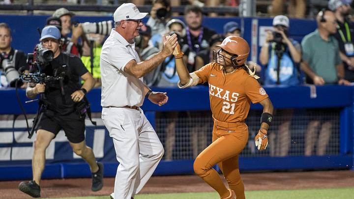 Jun 4, 2026; Oklahoma City, OK, USA;  Texas Longhorns outfielder Kayden Henry (21) shakes hands with head coach Mike Whit