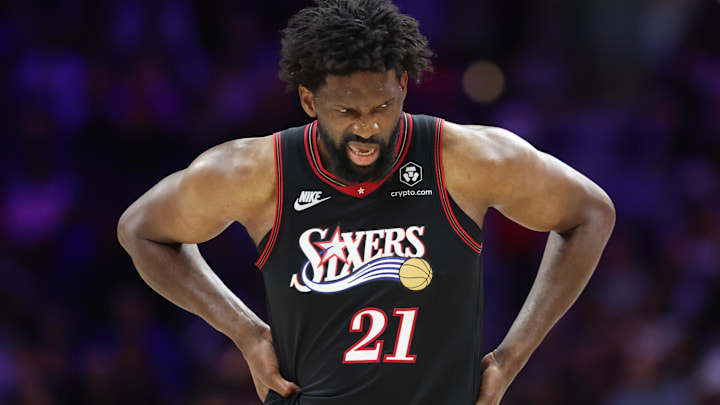 Feb 26, 2026; Philadelphia, Pennsylvania, USA; Philadelphia 76ers center Joel Embiid (21) reacts while clutching his body after a play against the Miami Heat during the second quarter at Xfinity Mobile Arena. Mandatory Credit: Bill Streicher-Imagn Images