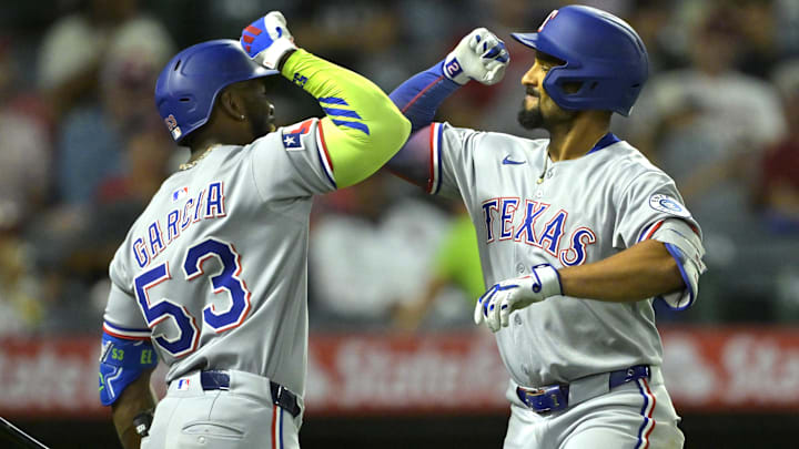 Jul 9, 2025; Anaheim, California, USA;  Texas Rangers second baseman Marcus Semien (2), right, is congratulated by right fielder Adolis Garcia (53) after hitting a two-run home run during the seventh inning against the Los Angeles Angels at Angel Stadium