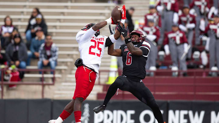 Jax State Gamecock Fred Perry and NMSU Jonathan Brady reach for the ball during a NMSU football game on Wednesday, May 22, 2023, at the Aggie Memorial Stadium.