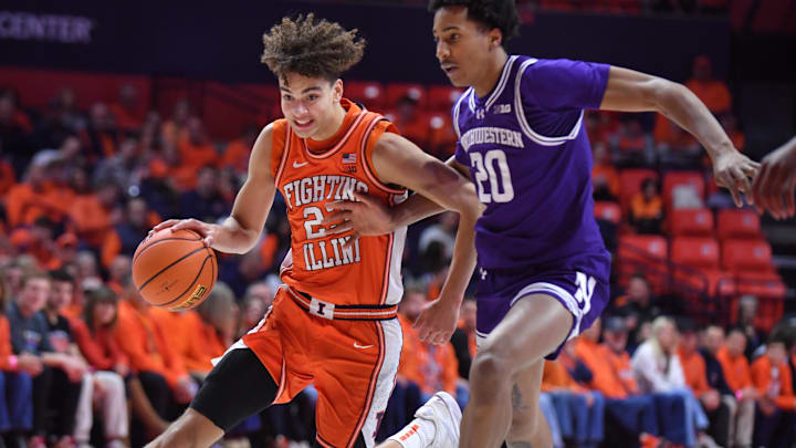 Feb 4, 2026; Champaign, Illinois, USA;  Illinois Fighting Illini guard Keaton Wagler (23) drives past Northwestern Wildcats guard Justin Mullins (20) during the first half at State Farm Center. Mandatory Credit: Ron Johnson-Imagn Images