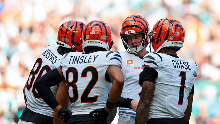Dec 21, 2025; Miami Gardens, Florida, USA; Cincinnati Bengals quarterback Joe Burrow (9) talks to his teammates Cincinnati Bengals tight end Mike Gesicki (88), Cincinnati Bengals wide receiver Mitchell Tinsley (82) and Cincinnati Bengals wide receiver Ja'Marr Chase (1) after a play  during the second quarter against the Miami Dolphins at Hard Rock Stadium. Mandatory Credit: Sam Navarro-Imagn Images