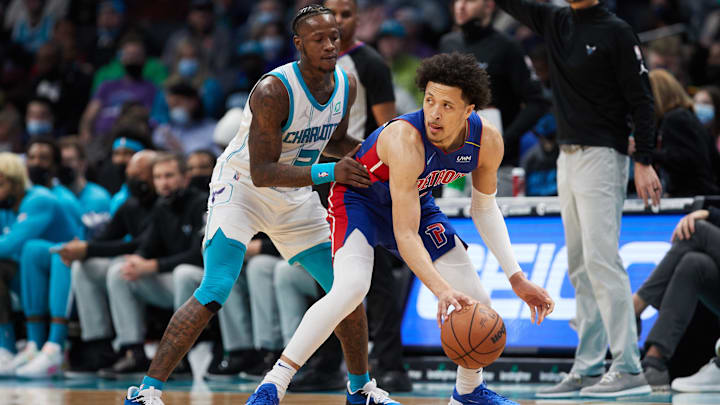 Jan 5, 2022; Charlotte, North Carolina, USA; Detroit Pistons guard Cade Cunningham (2) keeps the ball away from Charlotte Hornets guard Terry Rozier (3) during second half action at Spectrum Center. Mandatory Credit: Brian Westerholt-Imagn Images